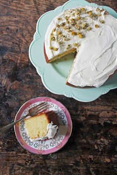 a piece of cake on a plate next to a slice of cake with white frosting and sprinkles