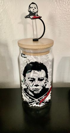 a glass jar with a drawing of a man and a monkey on it