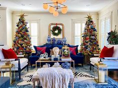 a living room decorated for christmas with blue and red furniture