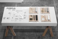 a white table with four pieces of wood on it and the words forsa written in black