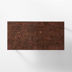 a wooden table top sitting on top of a white wall