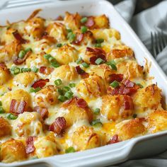 a casserole dish with bacon, green onions and cheese on it is ready to be eaten