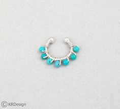 The one you see in the picture is a 18Ga, 8mm, non-pierced septum ring, with 2mm ball ends and 2mm Arizona Turquoise wrapped with silver. Very comfortable to wear and you can use it for your ears as well. I could also make it with other stones or crystals and if you sensitive to silver, in 14K white gold. Also, if you need it for a real septum ring, just leave me a note at your checkout~ ~Thank you for stopping by & supporting handmed! Have a blessed day~ ~KR :) Adjustable Nickel-free Blue Cartilage Earrings, Silver Septum Ring, Rose Gold Nose Ring, Tragus Ring, Cartilage Ring, Septum Rings, Gold Nose Stud, Gold Nose Rings, Piercing Shop