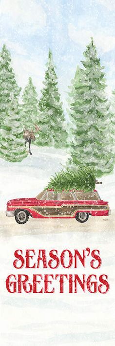 a red car with a christmas tree on the roof driving down a snow covered road