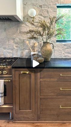 an image of a kitchen setting with wood cabinets and black counter tops, including a stove