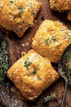 baked biscuits with herbs and salt on a wooden board next to a serving utensil