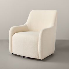 a white chair sitting on top of a gray floor