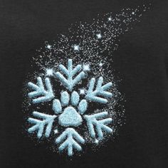 an image of snowflakes on a black shirt with sparkles in the air