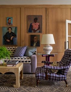 a living room filled with furniture and pictures on the wall