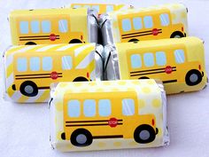 six yellow school bus candy wrappers sitting on top of each other