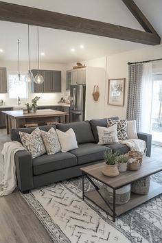 a living room filled with furniture and a large rug on top of a wooden floor