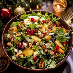 a salad with apples, walnuts and cranberries in a bowl on a table