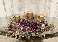 a glass table topped with candles and flowers