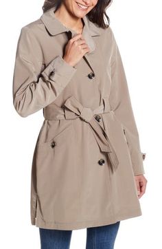 A belted waist adds a contemporary look to this button-up raincoat that's an outerwear essential. 34" length Notched lapels Button cuffs Removable tie belt Side slits Water-resistant Lined 100% polyester Machine wash, tumble dry Imported Belted Raincoat For Fall, Classic Belted Raincoat For Work, Winter Workwear Belted Raincoat, Solid Belted Button-up Outerwear, Belted Button-up Outerwear For Business, Belted Button-up Business Outerwear, Belted Business Outerwear, Elegant Solid Color Fall Raincoat, Tie Belt