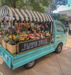 a blue truck with flowers on the back