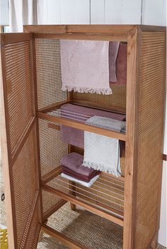 a wooden shelf with towels on top of it