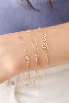 ITEM INFO Elevate your everyday style with the 14K Solid Gold Double Plain and Satellite Chain Bracelet, a stunning piece that combines minimalist beauty with contemporary flair. This bracelet features a luxurious double-chain design, consisting of one sleek plain chain and a satellite chain adorned with delicate gold beads. Crafted from high-quality 14K solid gold, this bracelet adds a touch of sophistication and sparkle to any outfit, whether worn alone or layered with other pieces. Its elegant design makes it perfect for both everyday wear and special occasions. Key Features: Material: Premium 14K solid gold for a radiant, long-lasting shine Design: Double-chain style featuring a classic plain chain and a satellite chain with polished gold beads Style: Versatile and elegant, perfect for Minimalist 14k Gold Double Chain Jewelry, Modern Double Chain Bracelet For Everyday, Modern Double Chain Bracelet As Gift, Minimalist Double Chain Bracelets As Gift, Elegant Double Strand Bracelet With Delicate Chain, Minimalist Double Chain Bracelet As Gift, Minimalist Double Chain Bracelet For Gift, Elegant Everyday Bracelet With Double Chain, Elegant Bracelet With Adjustable Chain For Layering