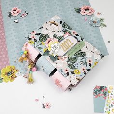 an assortment of paper and crafting supplies on a table