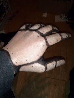 a person's hand with black and white dots on it