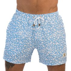 Elevate your summer style with East x East Blue Haven men's shorts. The playful white dot design on a blue background adds a touch of fun to any outfit. Made with premium sustainable materials, our shorts provide maximum comfort, durability, and flexibility while also being eco-friendly. The elasticated waist and drawstring adjustment ensure a comfortable and secure fit, whether you're surfing, swimming, or just lounging around. Model wears size: M Sustainable Sunglasses, Blue Swimsuit, Dot Design, Dots Design, Sustainable Materials, Resort Wear, Blue Background, Blue Backgrounds, Men's Shorts