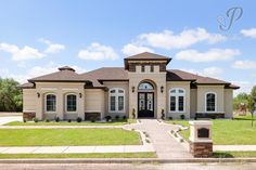 a large house with lots of windows and grass