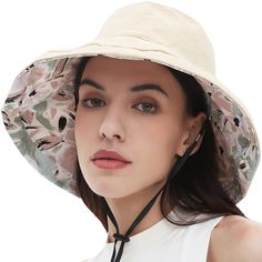 a woman wearing a white hat with floral print on the brim and black cord