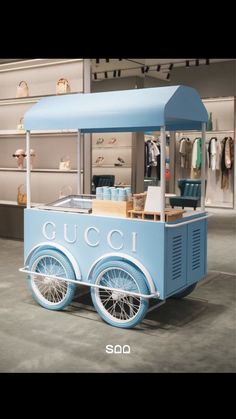 an ice cream cart is shown in the middle of a room with other items on display