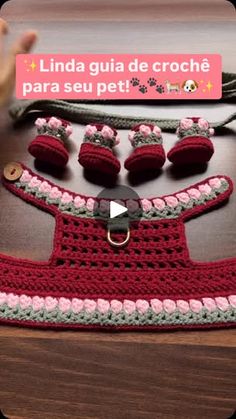 a crocheted red dress with matching shoes and bracelets is displayed on a table