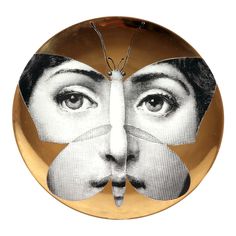 a plate with an image of a woman's face and a butterfly on it