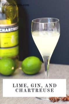 lime gin, and chartreuse cocktail in a wine glass next to some lemons