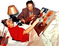 two men laying in bed with pizzas on top of the sheets and one man holding an open book