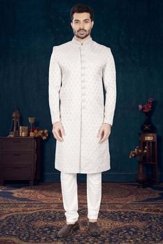 Make a statement with our Mens Sherwani- V2-S041! Perfect for grooms, this sherwani is adorned with elegant cutdana and pearls, adding a touch of sophistication to your wedding day look. Stand out from the crowd and feel like royalty on your special day. Don't miss out on this timeless piece! Reception Bandhgala With Pearl Embroidery, Traditional Wedding Sherwani With Pearl Embroidery, Reception Sherwani With Pearl Embroidery In Traditional Drape, Festive Sherwani With Pearl Embroidery, Traditional Drape Sherwani With Pearl Embroidery For Wedding, Off White Formal Bandhgala With Traditional Drape, Elegant Sherwani With Pearl Embroidery For Diwali, Off White Naqshi Bandhgala For Formal Occasions, Elegant Bandhgala With Naqshi For Reception