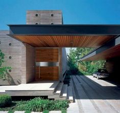 the entrance to a modern house with steps leading up to it