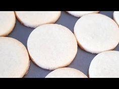 several white cookies sitting on top of a pan