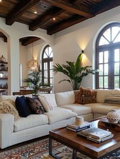 a living room filled with furniture and large windows