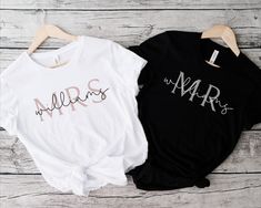 two t - shirts with the word mr and mrs printed on them sitting next to each other