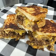 two grilled cheese sandwiches stacked on top of each other with meat and cheese in the middle