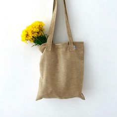 The perfect everyday tote! Great for use as a purse, produce bag, beach bag, and much more! Handmade out of recycled fabric in small batches. Shipped in a biodegradable envelope  - handmade! - dimensions: 16inx14in - handle length: 17in - Machine wash cold, hang dry - NOTE: may not appear exactly as pictured due to different cuts of fabric  - NOTE: once a pattern is sold out it is gone for good! Eco-friendly Everyday Reusable Shoulder Bag, Eco-friendly Natural Canvas Bag For Everyday Use, Eco-friendly Everyday Reusable Canvas Bag, Brown Reusable Bag, Brown Reusable Everyday Bag, Eco-friendly Ethically Sourced Bag For Daily Use, Brown Everyday Reusable Bag, Everyday Brown Reusable Bag, Recyclable Canvas Tote Bag For Everyday Use