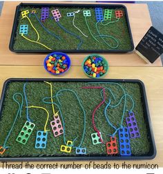 two trays filled with toys on top of green grass