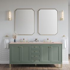 two mirrors are above the double sink vanity in this white bathroom with green cabinetry