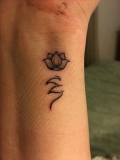 a small lotus tattoo on the side of a woman's arm and foot,