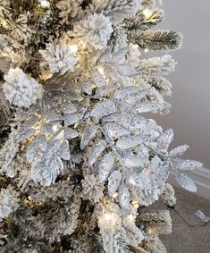 a white christmas tree with snowflakes on it