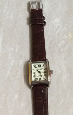 Vellacio women's silver watch, having a rectangle lumibrite "glow in the dark" dial, displaying black roman numeral hours, all on a brown leather band. this is a new unused vintage watch, ready to be cherished & enjoyed! this item will arrive in perfect working condition in a velvet watch pouch and would make an awesome gift item. measurements: bezel/case 1 1/8" x 3/4", dial 3/4" x 5/8", band width 1/2" and fits a 5.25" up to a 7" wrist, perfectly. we ship fast, the next business day for a quick delivery to you. may you have a wonderful time shopping, best wishes! Rectangle Watch Women, Rectangle Watch, 2024 Wishlist, Silver Watches Women, Brown Watches, Roman Numeral, Women's Watch, Roman Numerals, Quick Delivery