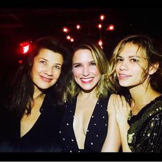 three women are posing for the camera at a party