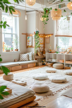 a living room filled with lots of furniture and plants hanging from the ceiling above it