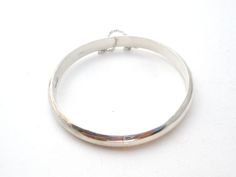 Fine Jewellery - This is a round high polished sterling silver bangle bracelet. It is hallmarked 925, signed FAS, slightly over .25" wide, inside diameter is 2.25", inside circumference is 7.25", and weighs 8.3 grams. It has sliding in locking clasp and safety chain. Any darkness or discoloration is only reflections. Silver Bangle With Sterling Silver Clasp, Classic Round Bangle Stamped 925, Silver Oval Bangle With Polished Finish, Silver Polished Round Bangle, Silver Round Bangle With Polished Finish, Silver Bangle With Polished Finish, Formal Round Cuff Bracelet Stamped 925, Classic Hallmarked Sterling Silver Bangle Bracelet, Adjustable Bangle With Sterling Silver Clasp