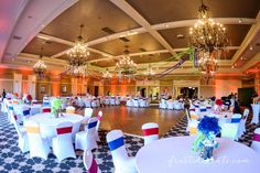 a banquet hall with tables and chairs decorated in red, white, and blue colors