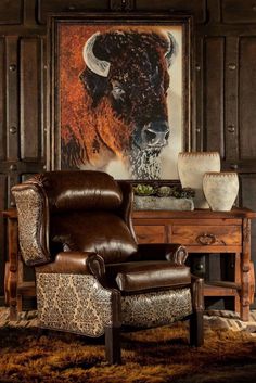 a living room with a cow painting on the wall and a chair in front of it