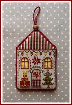 a small house ornament hanging on a table