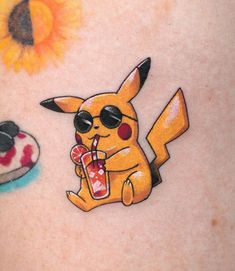 an image of a pokemon tattoo on the back of a woman's stomach with a cake and sunflower